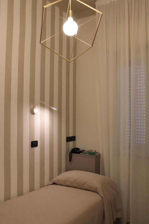 Postel nebo postele na pokoji v ubytování Hotel Piccinelli