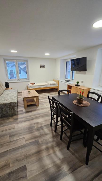 a living room with a table and a couch at Apartmány U Provazníka in Zdíkov