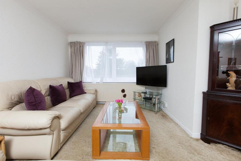 a living room with a couch and a coffee table at GuestReady - Spacious 2BR Flat in Peaceful Hove in Brighton & Hove