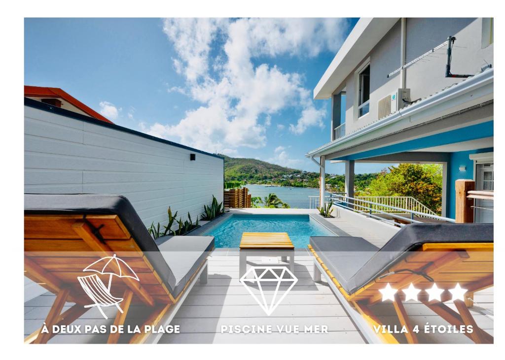 une maison avec une piscine à côté d'un bâtiment dans l'établissement Sublime Villa Piscine - Trésor de la Baie, à La Trinité