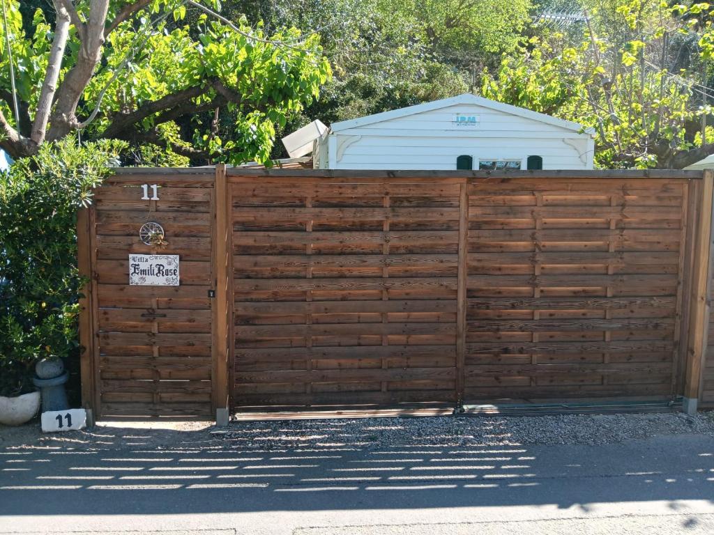 a wooden gate with a sign on top of it at La Caseta in Xàtiva