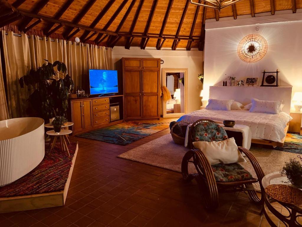 a bedroom with a bed and a tv in it at En las Nubes in Medellín