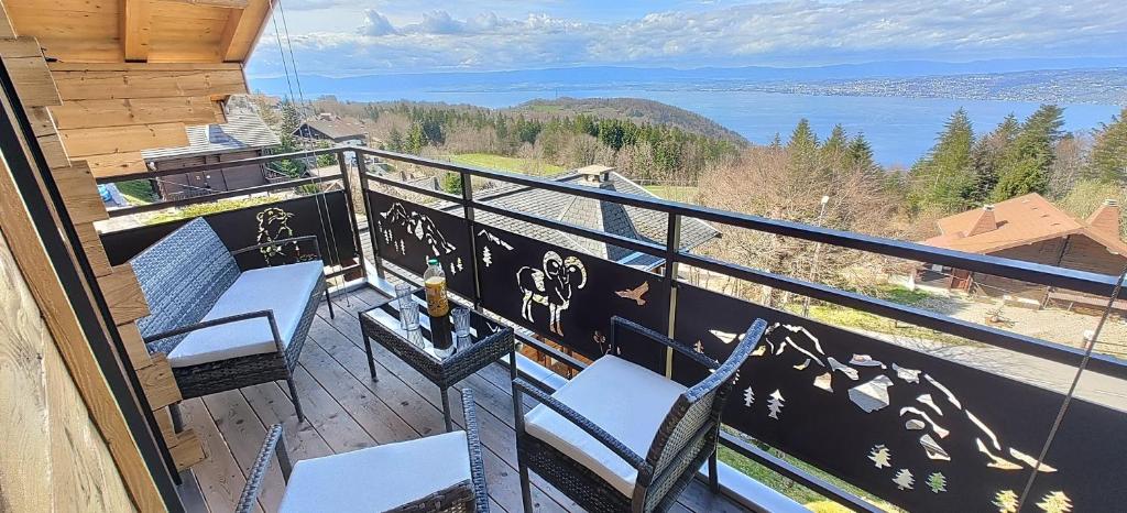 a balcony with chairs and a view of the water at Chalet La Trouvaille in Thollon