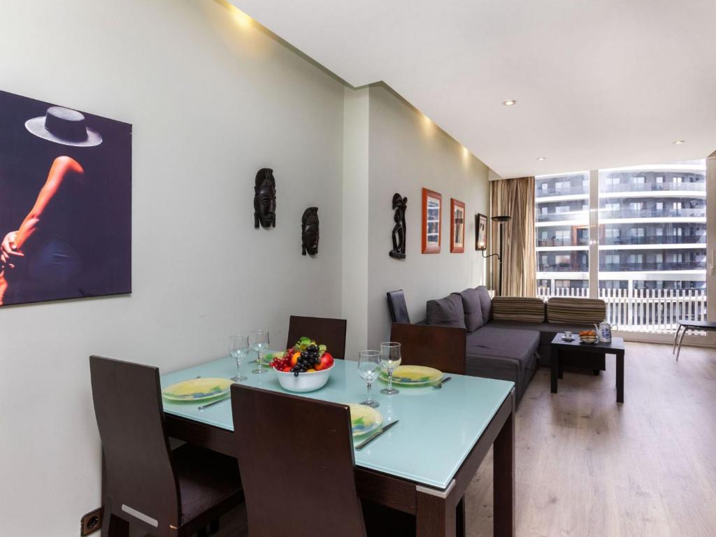 een woonkamer met een tafel en een bank bij Apartment Sants-Montjuic Rambla Badal by Interhome in Barcelona