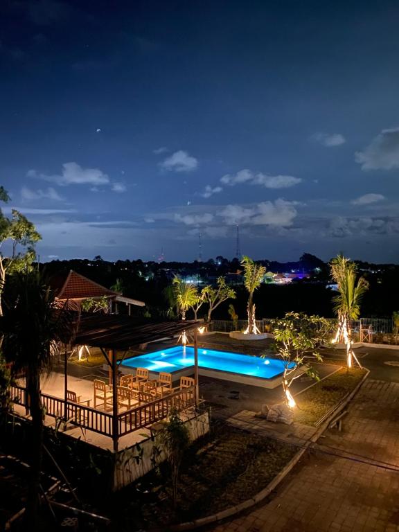 a view of a swimming pool at night at The Akasea Villa Bali in Ungasan
