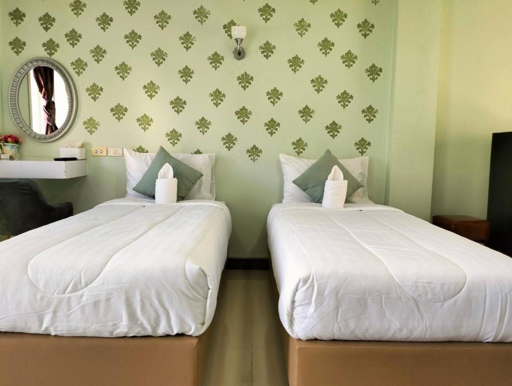 Postel nebo postele na pokoji v ubytování aSleep Hotel Sriracha แอสลีพ โฮเทล
