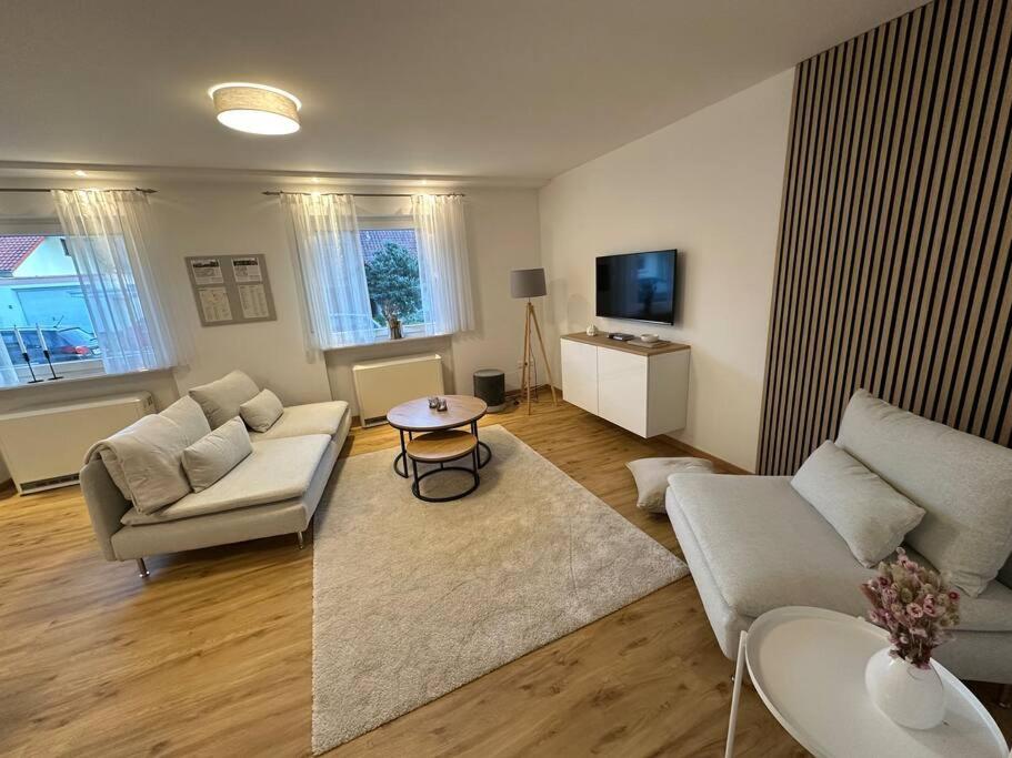 a living room with a couch and a table at Apartment PfalzGlück in Dahn