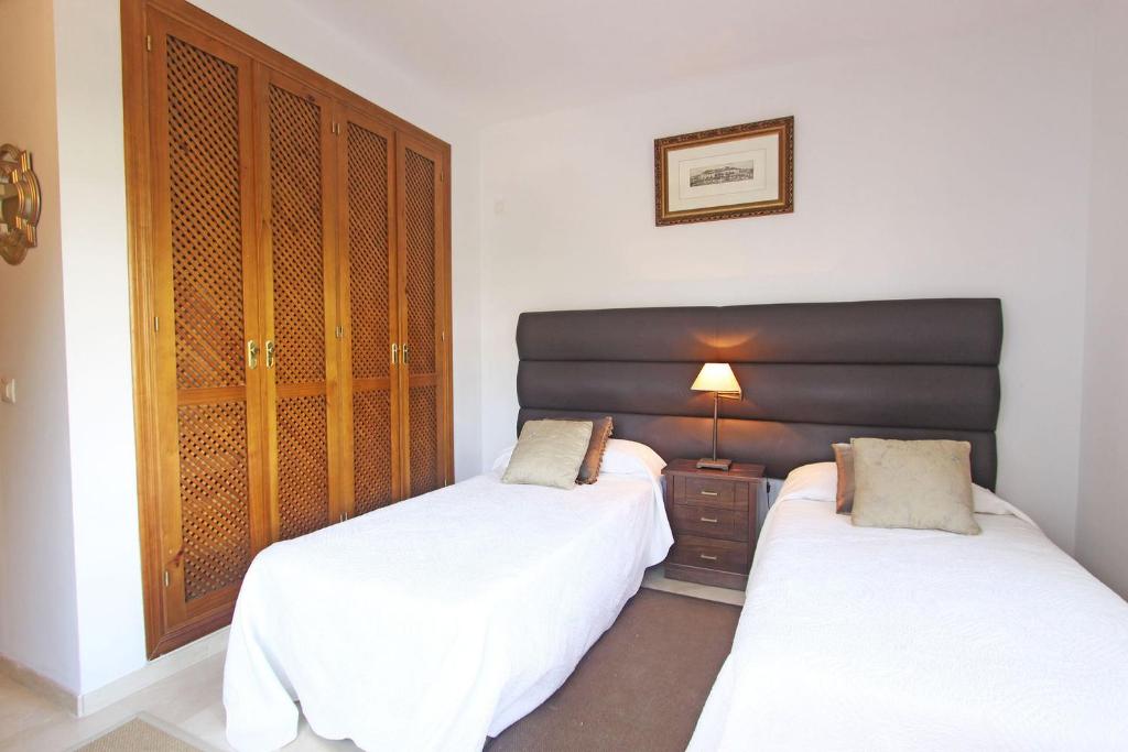 A bed or beds in a room at 1126 BEACHFRONT HIGH STANDARD APARTMENT WITH TERRACE