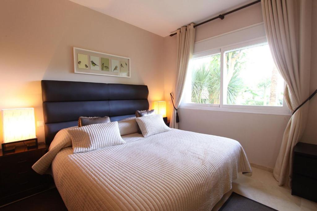 A bed or beds in a room at 1126 BEACHFRONT HIGH STANDARD APARTMENT WITH TERRACE