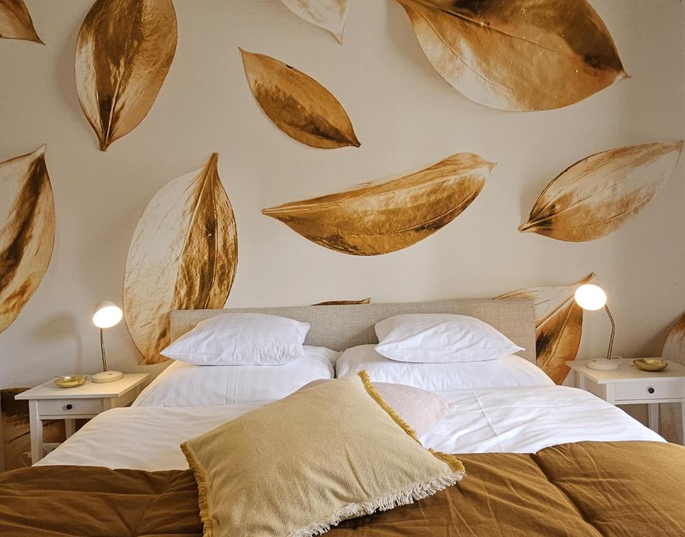 two beds in a bedroom with leaves on the wall at Golden Flat by GrazRentals with parkview - brandnew & free parking in Graz