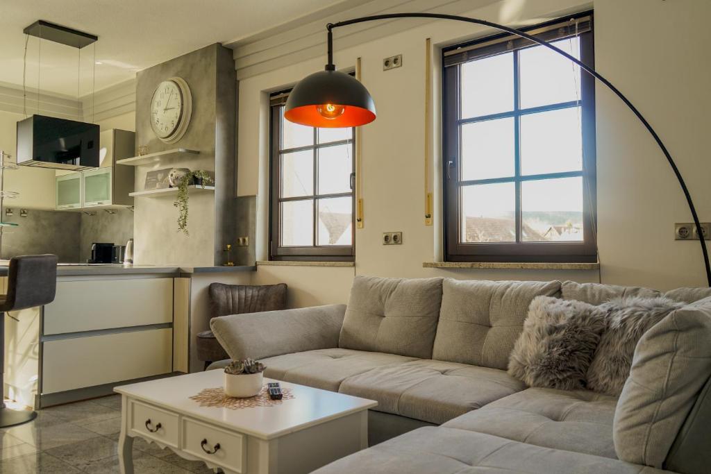 a living room with a couch and a table at 2-Raum App mit Terrasse Jena Zöllnitz in Jena