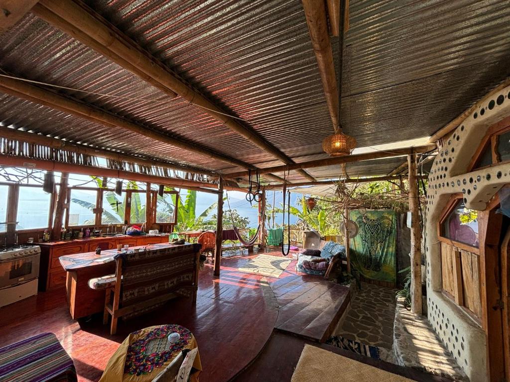 a large living room with a view of the ocean at Earthship 3 levels FAMILY apartment with lake view in San Marcos La Laguna