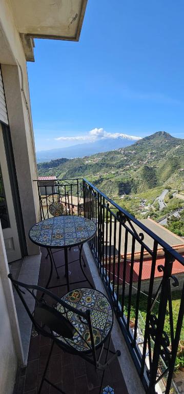 two tables and chairs on a balcony with a view at La Casa di Giò in Taormina