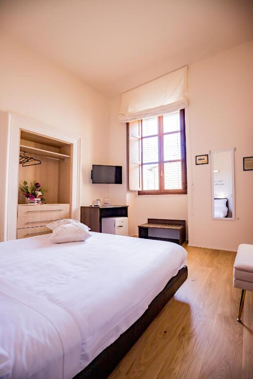 Postel nebo postele na pokoji v ubytování La Torre Rooms