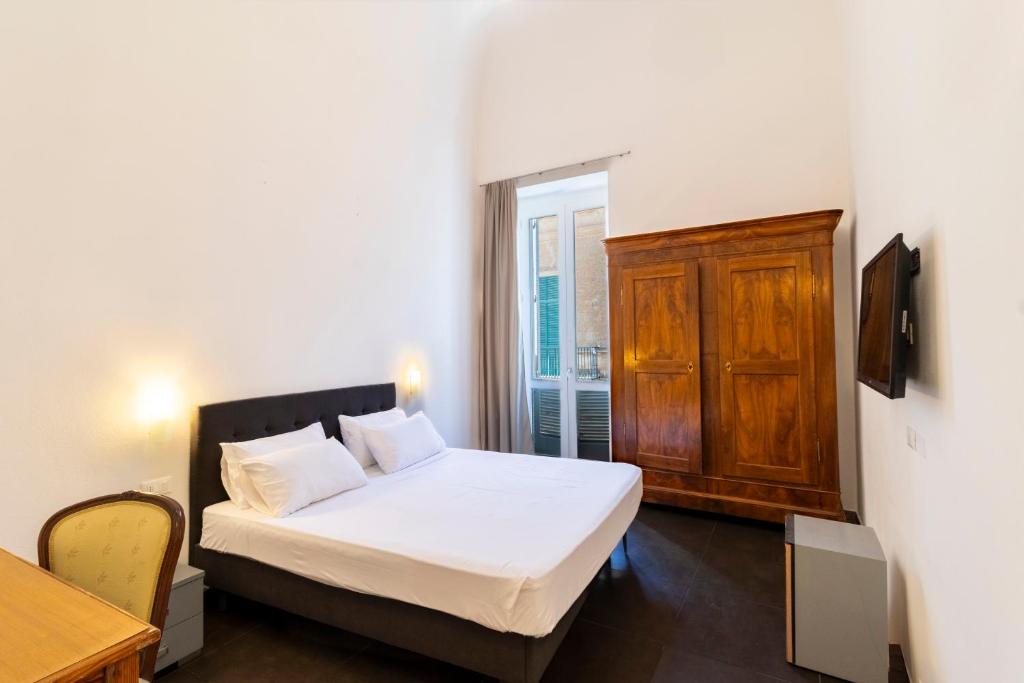 Postel nebo postele na pokoji v ubytování Palazzo Cavour