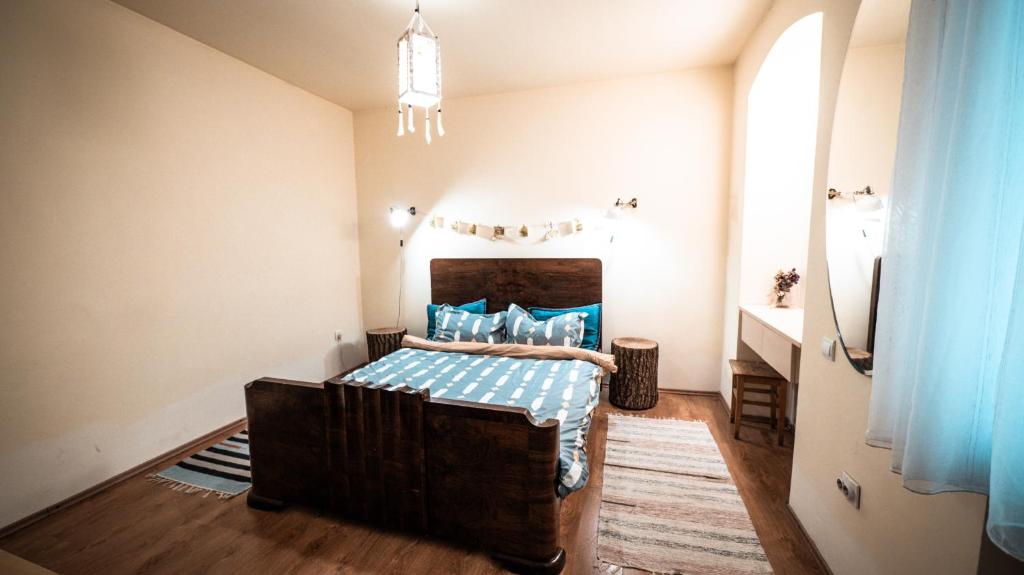 a bedroom with a bed with blue pillows at Heart of the city II in Braşov