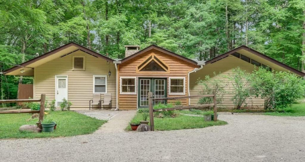 a log house with a driveway in front of it at Shady Woods Cabin in Gatlinburg