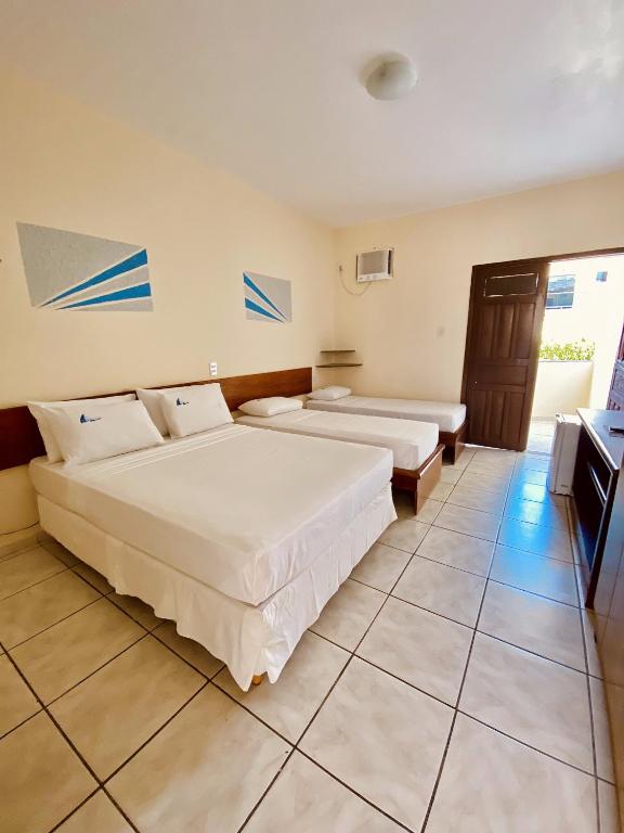 Postel nebo postele na pokoji v ubytování Hotel Porto das Ancoras