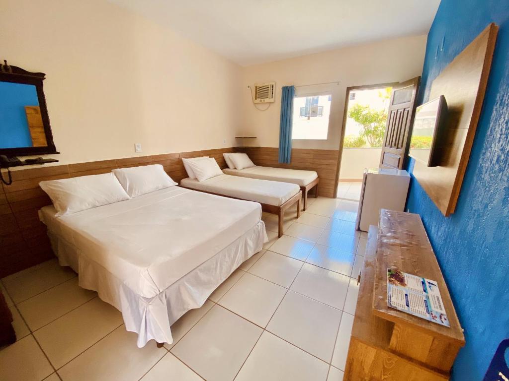 Postel nebo postele na pokoji v ubytování Hotel Porto das Ancoras
