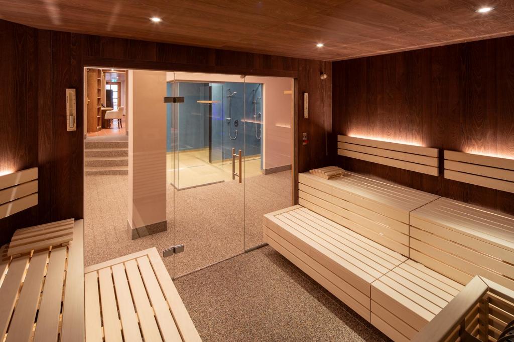 a sauna with benches and a walk in shower at Hotel Zum Schwarzen Bären in Emmersdorf an der Donau