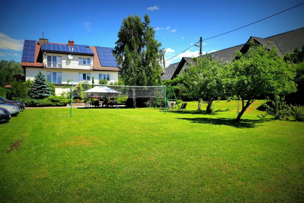 a yard with a soccer net in front of a house at GoGreen Hotel in Rząska