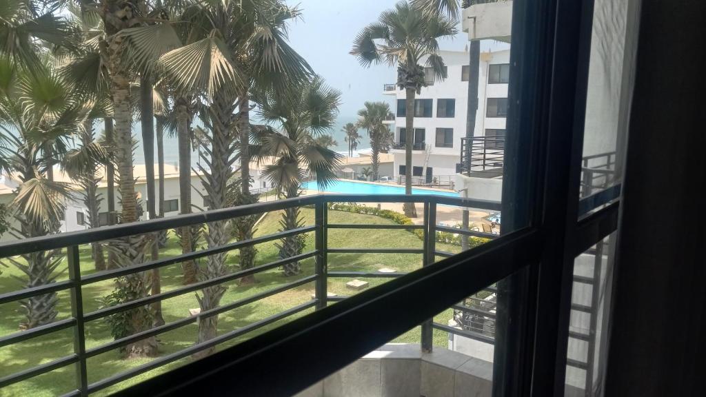 a view of a swimming pool from a window at Relax Waterfront Apartments. in Bijilo