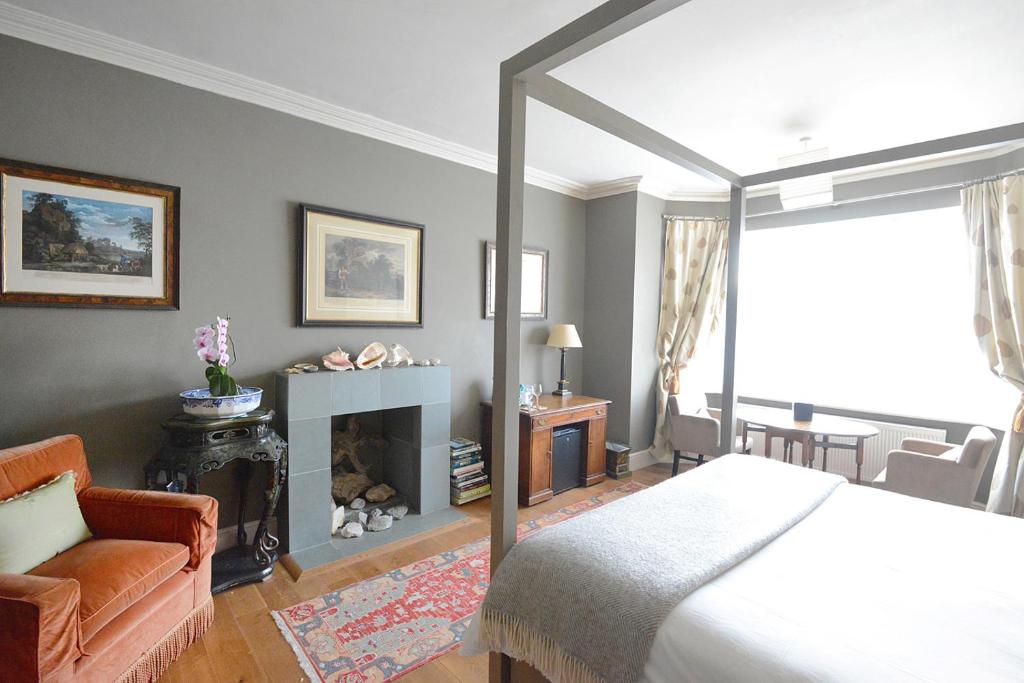 a bedroom with a large bed and a fireplace at The Cloudesley Guesthouse in Hastings