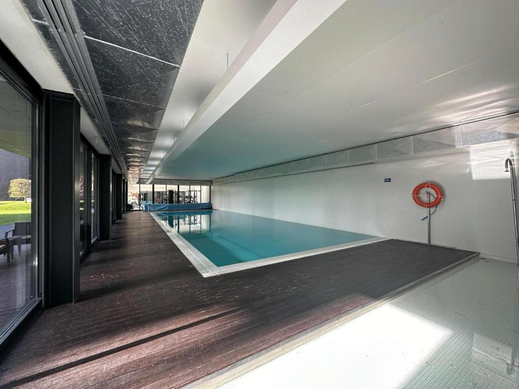 a swimming pool in the middle of a building at Lovely Apartment at Quinta da Portela - Coimbra in Coimbra