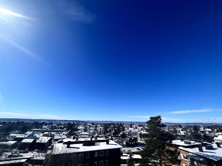 a view of a city with snow covered roofs at Koselig leilighet på Nordstrand/Lambertseter, Oslo in Oslo