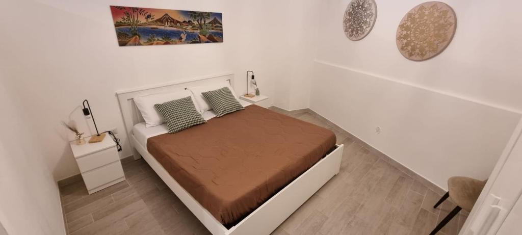 a white bedroom with a bed in a room at Loft Crispi in Bari