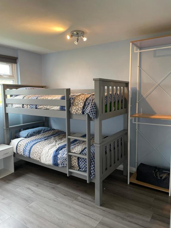 a bedroom with two bunk beds in a room at Chalet at Penstowe Holiday Park Near Bude in Bude