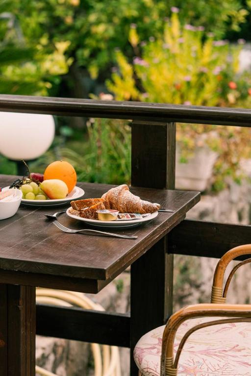 a table with two plates of food and fruit on it at Hotel Belvedere in Sperlonga