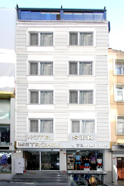 a white building with a hotel in front of it at Metrohill Hotel in Istanbul