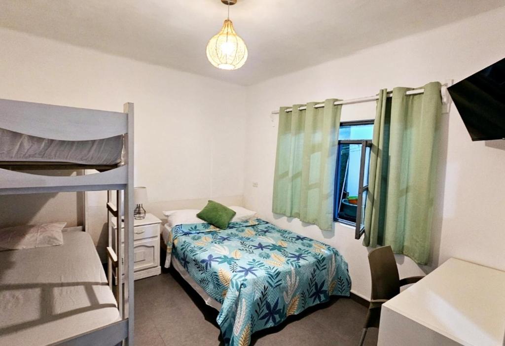 een slaapkamer met 2 stapelbedden en een raam bij Casa de Playa Tortugas Casma, Habitación 4 a 6 personas con 1 baño in Tortuga