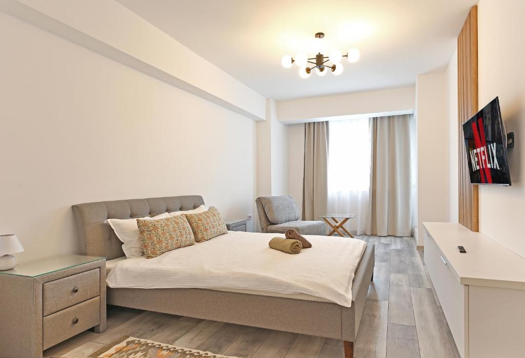 a bedroom with a bed and a chair in it at Ada Homes 07 in Braşov