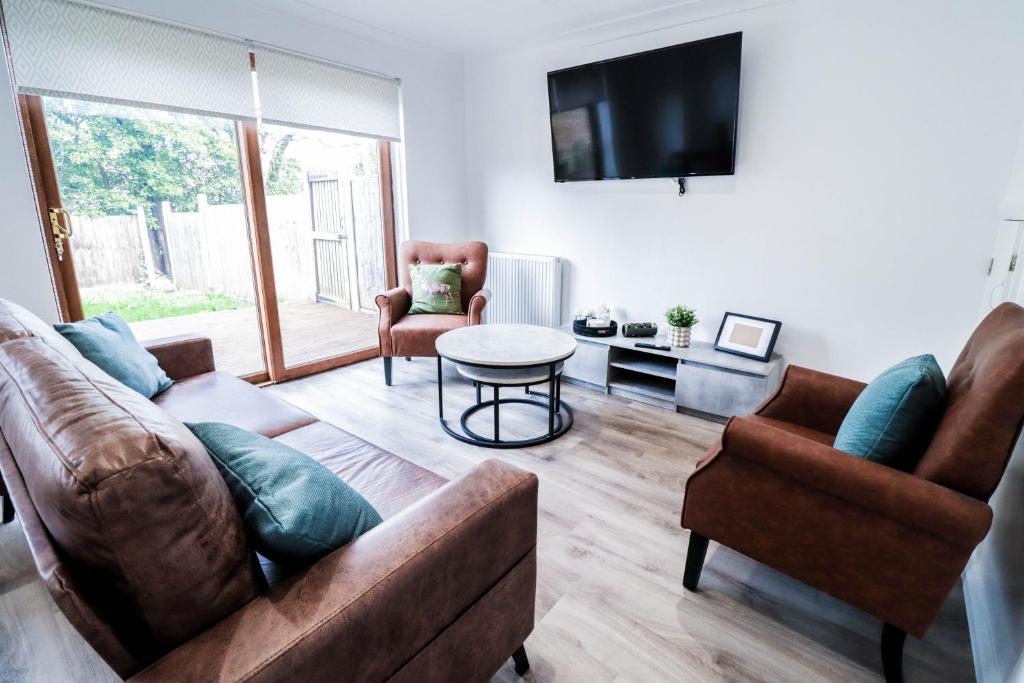 a living room with a couch and a table at Tranquil 3BR Retreat for Families in Bexleyheath in Bexleyheath