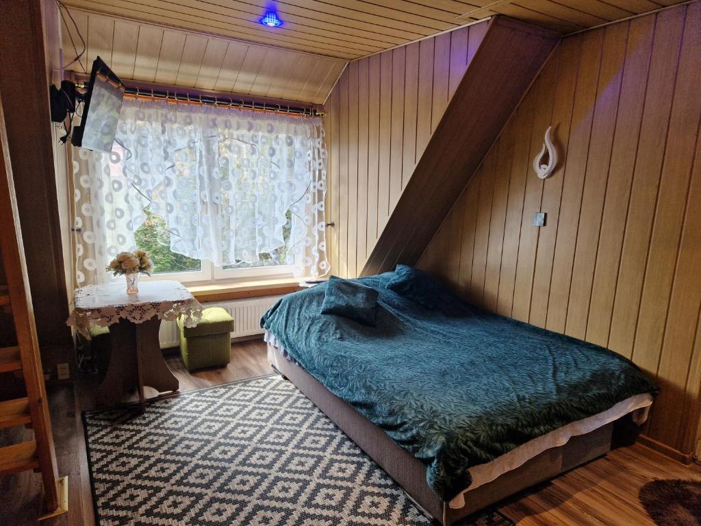 A bed or beds in a room at Pokój pod lasem u Ewki
