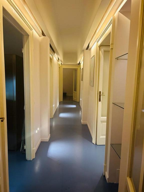 an empty hallway with white walls and a long corridor at B&B Boutique in Milan