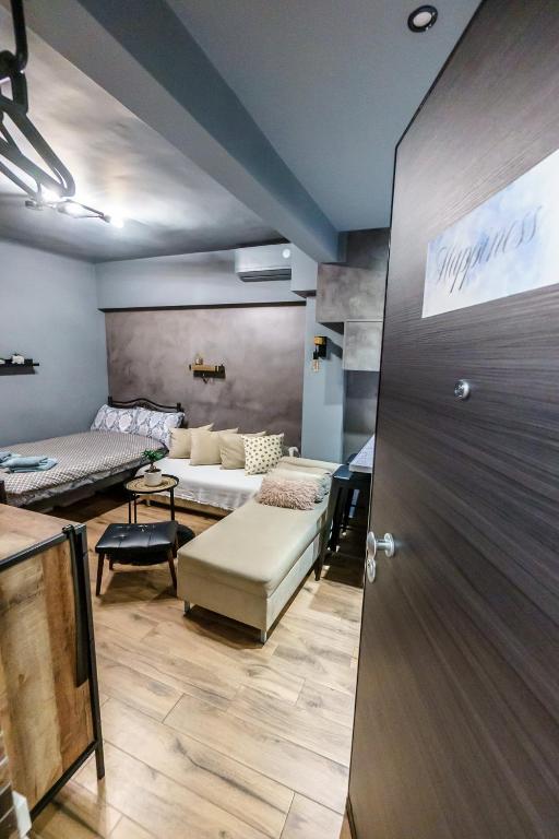 a living room with a couch and a table at Happiness studio with terrace. in Thessaloniki