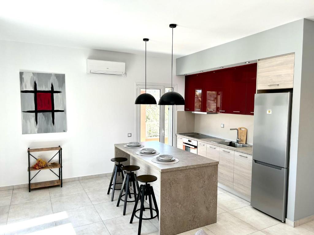 a kitchen with a island with bar stools at Bridge House Corfu in Potamós