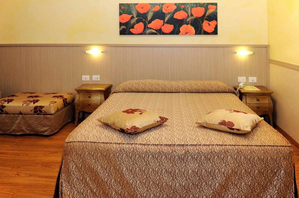 Postel nebo postele na pokoji v ubytování Hotel Corallo