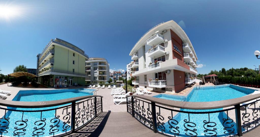 a resort with two swimming pools and a building at Hotel Zaara in Sunny Beach