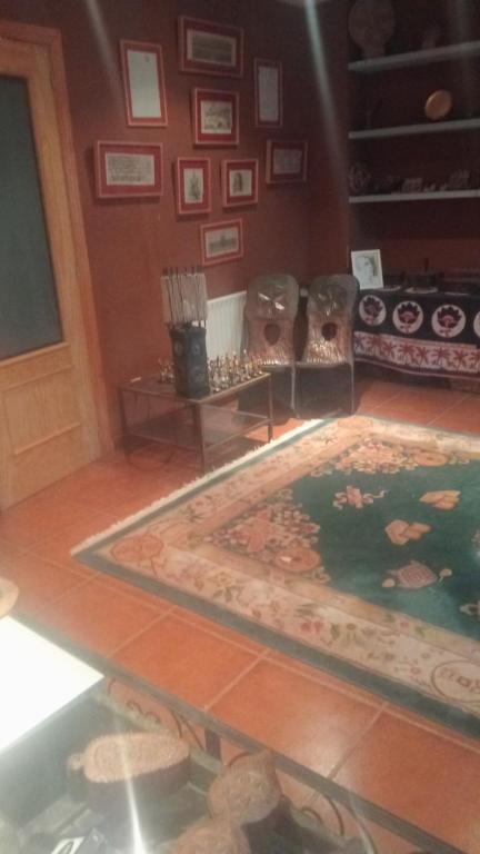 a room with a rug on the floor and a staircase at Valarya in Cercedilla