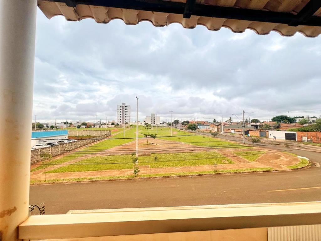 a view of a field from a window at Loft Famíliar Br/Aeroporto 22 in Uberlândia