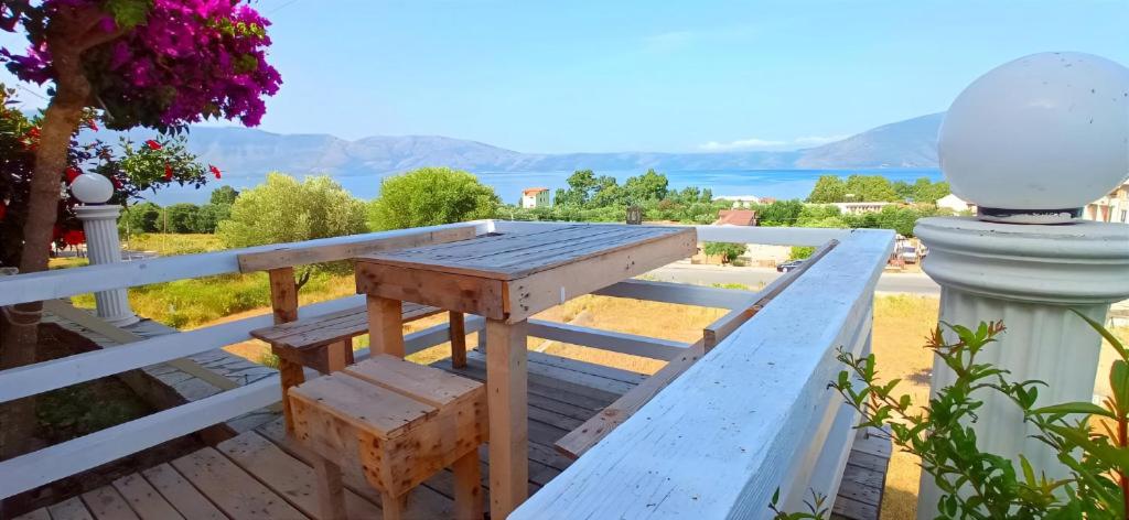 a wooden bench sitting on top of a white fence at Hotel Sirena in Vlorë