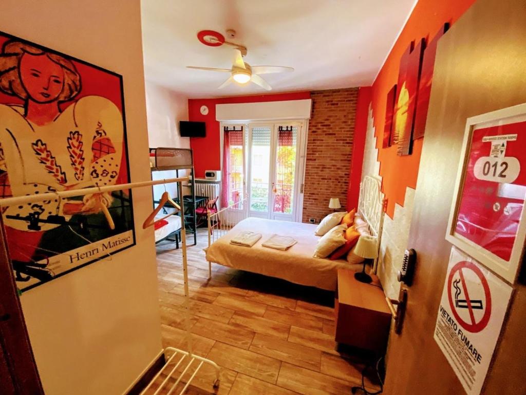 a small room with a bed and a room with at Europe Station Rooms in Parma