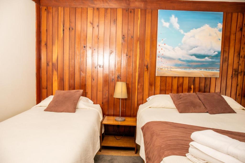 Postel nebo postele na pokoji v ubytování Hotel Hosteria Entre Lagos