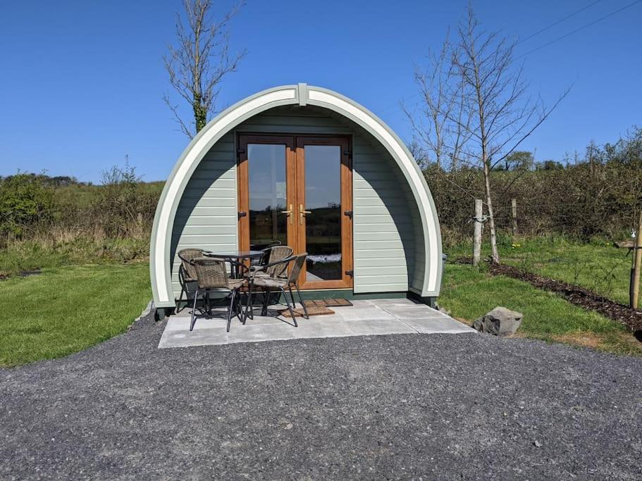 a dome tent with a table and chairs on a patio at Killynick Marina Glamping Rose in Fivemiletown