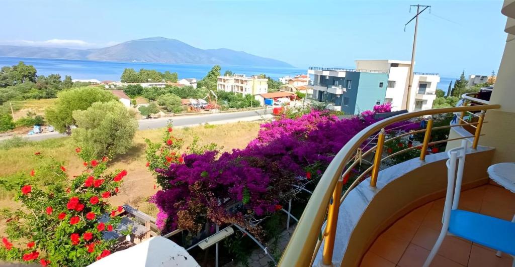a balcony with flowers and a view of the water at Hotel Sirena in Vlorë
