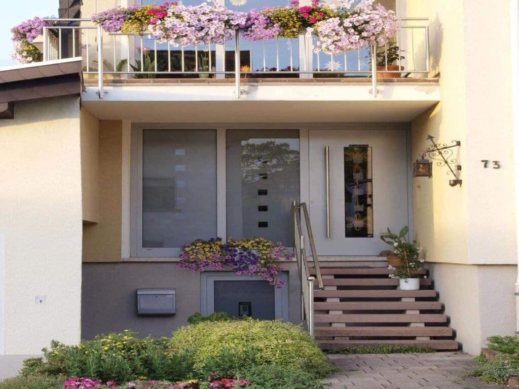 a house with flowers hanging from a balcony at Holiday apartment Sunflower in Marpingen